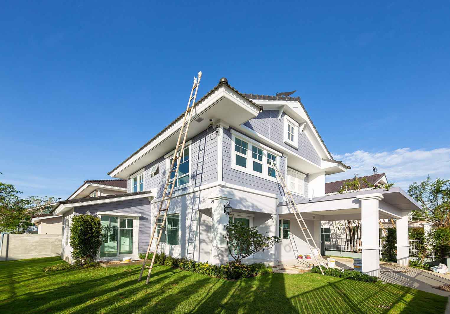 House exterior with ladders for painting