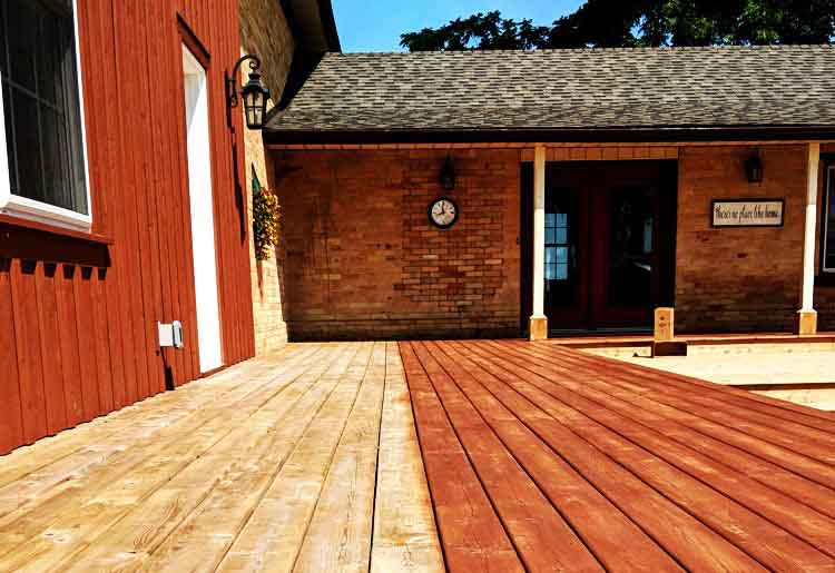 Deck being stained, half stained half natural